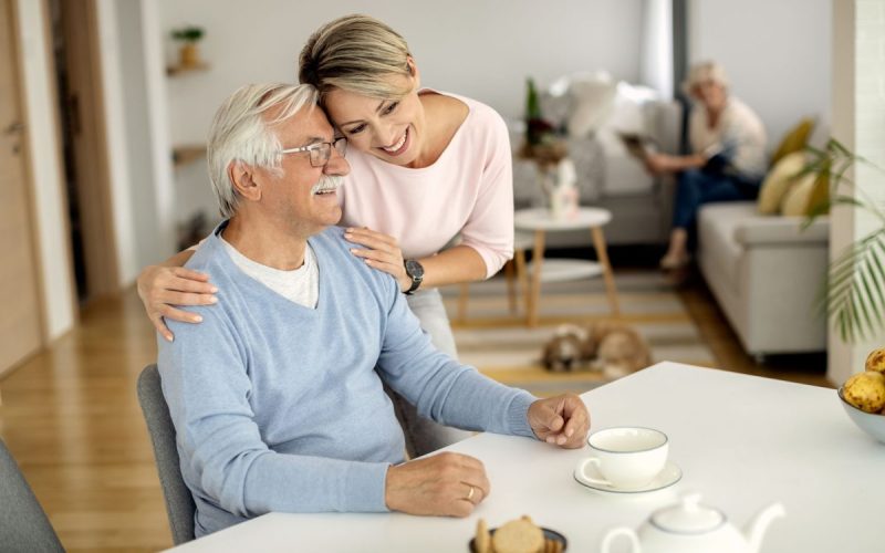 happy-woman-embracing-her-senior-father-home